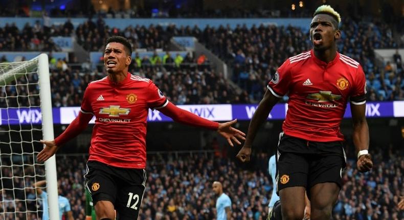 Manchester United's Chris Smalling and Paul Pogba celebrate a famous 3-2 win in April that delayed Manchester City's title celebrations