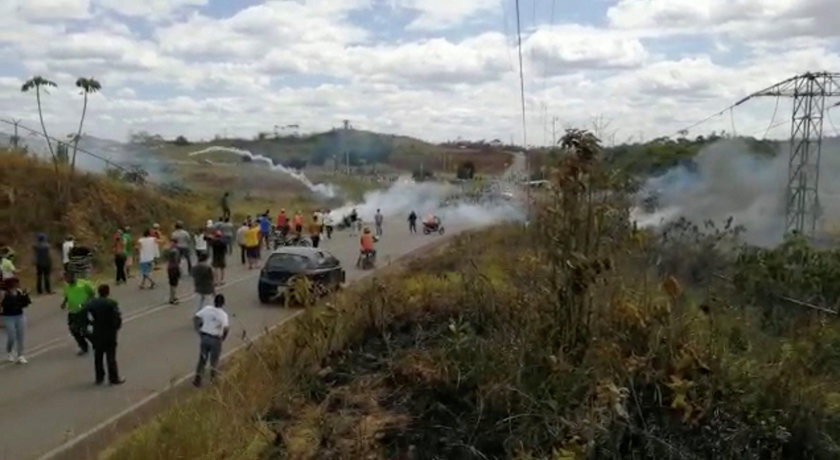 People look on as tear gas this thrown in Santa Elena De Uairen