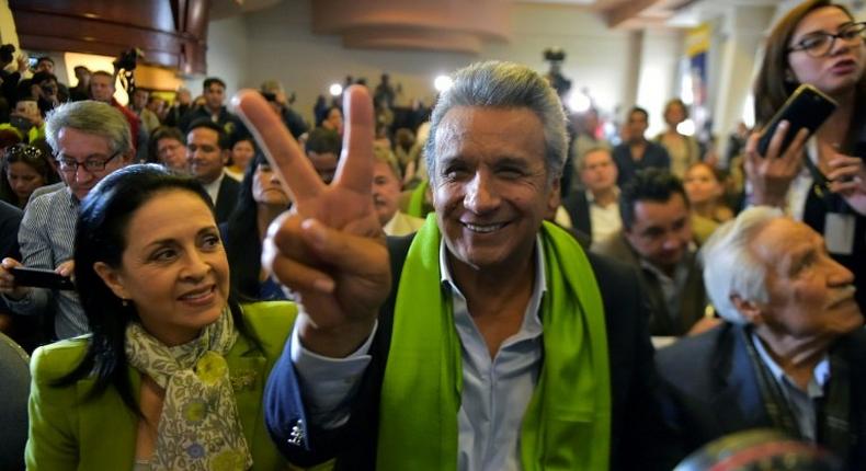 The Ecuadorean presidential candidate of the ruling Alianza PAIS party, Lenin Moreno, next to his wife Rocio Gonzalez (L), listens to the first results of the runoff election, in Quito on April 2, 2017