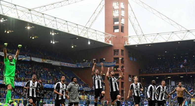 Juventus' players celebrate after the Italian Serie A football match against Sampdoria on March 19, 2017 at the Luigi Ferraris stadium in Genova