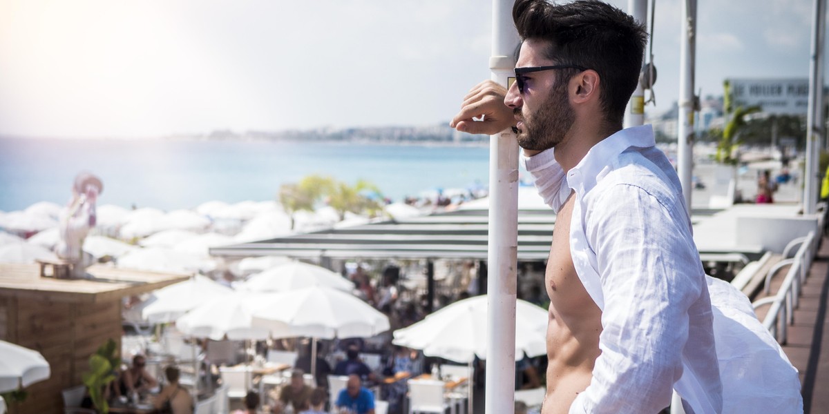 Attractive athletic young man on seaside promenade