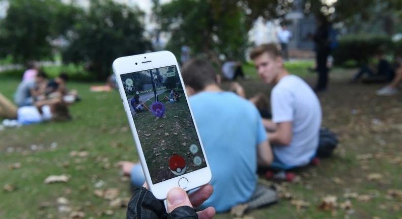 Hunting Pokemon at a park in Russia, where a blogger is on trial for posting a video of him playing the game in a church