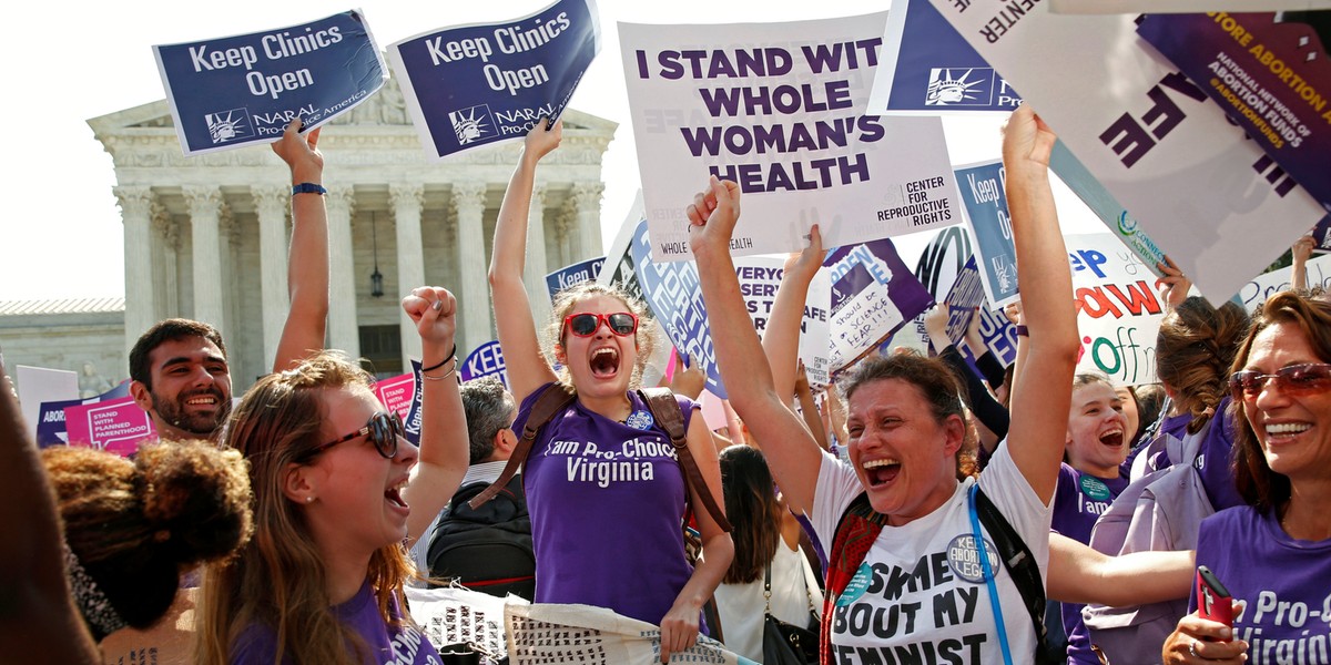 Demonstrators celebrate at the US Supreme Court after the court struck down a Texas law imposing strict regulations on abortion doctors and facilities that its critics contended were specifically designed to shut down clinics in Washington, June 27, 2016.