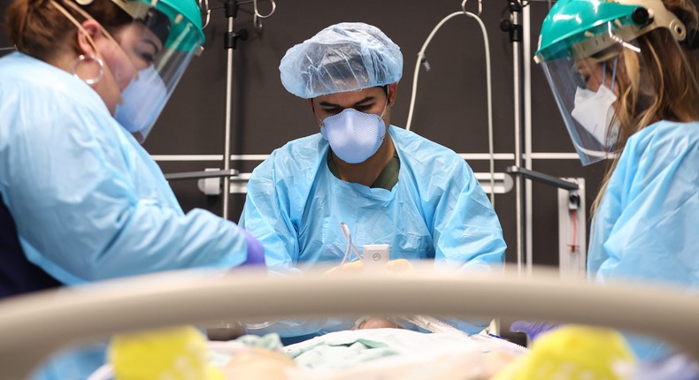 Clinicians work to intubate a COVID-19 patient in the ICU at Lake Charles Memorial Hospital in Lake Charles, Louisiana, on August 10, 2021.
