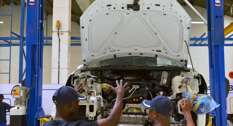 Technicians work on a Polo Vivo at a new assembly plant in Kenya's Thika industrial area, on December 21, 2016