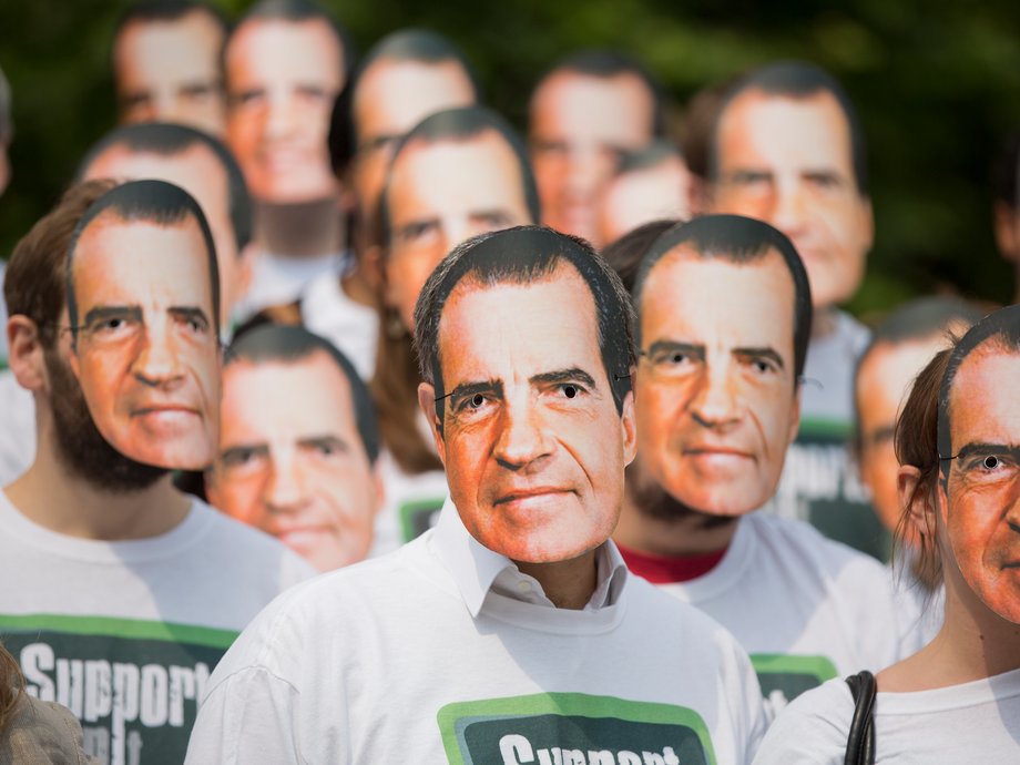 Protesters from the "Support, Don't Punish" campaign group wear masks depicting former US President Richard Nixon to demonstrate against the criminalization of drug use in London June 26, 2013.