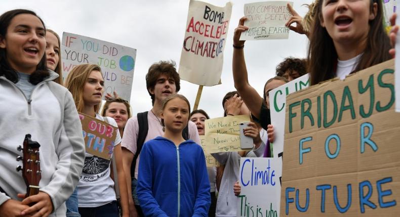 Swedish climate activist Greta Thunberg (C), 16, has inspired a worldwide youth movement demanding governments take action on climate change