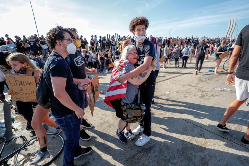 Protesters scale a truck that was driven into a rally