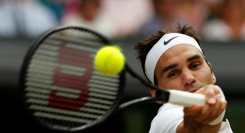 Switzerland's Roger Federer returns against Croatia's Marin Cilic during their men's singles final match on the last day of the 2017 Wimbledon Championships July 16, 2017