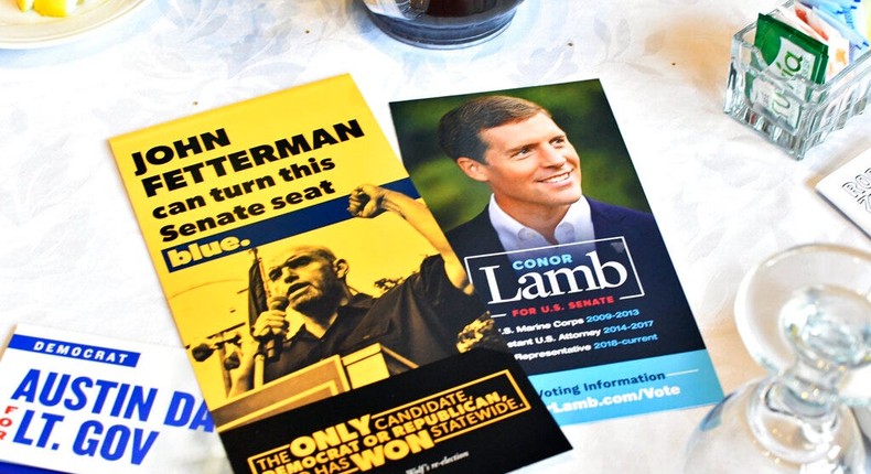 Literature for Conor Lamb and John Fetterman appear on a table where both Democratic candidates for Senate were speaking at a Centre County Democratic breakfast event at a hotel at the Mountain View Country Club in Boalsburg, Pa., on April 9, 2022.