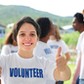 happy volunteer girl showing thumbs up sign