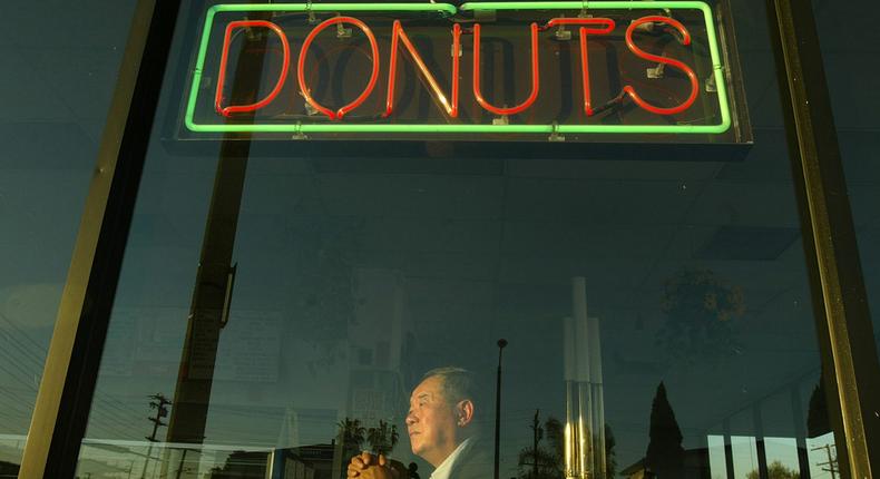 Ted Ngoy, founder of Christy's Donut Shops, sits in one of his businesses in 2004.Gary Friedman/Getty Images