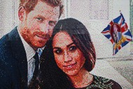 A girl waves a flag next to a LEGO brick mosaic of Britain's Prince Harry and Meghan Markle in Windsor