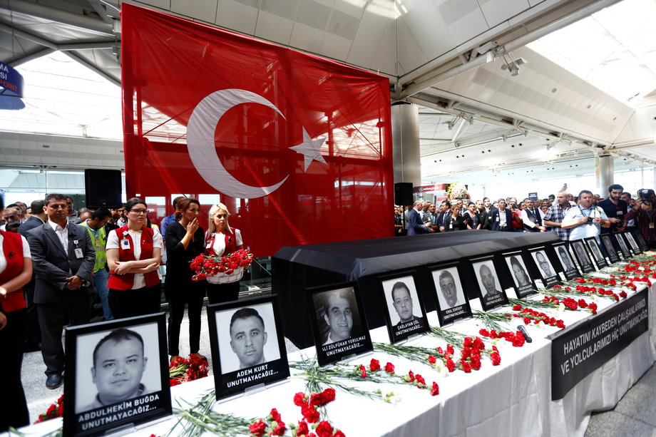 Airport employees attend a ceremony for their friends, who were killed in an attack at the airport, at the international departure terminal of Ataturk airport in Istanbul.