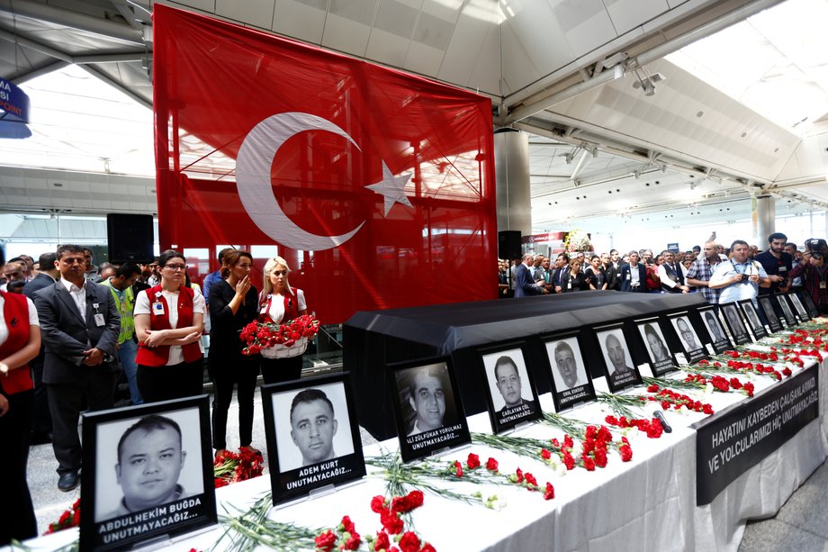 Airport employees attend a ceremony for their friends, who were killed in an attack at the airport, at the international departure terminal of Ataturk airport in Istanbul.