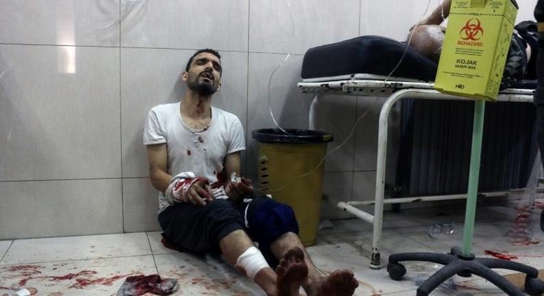 A wounded man sits on the floor in a crowded makeshift hospital in eastern Aleppo as regime aircraft and artillery pounded neighbourhoods in the rebel-held sector of Syria's second city on November 18, 2016