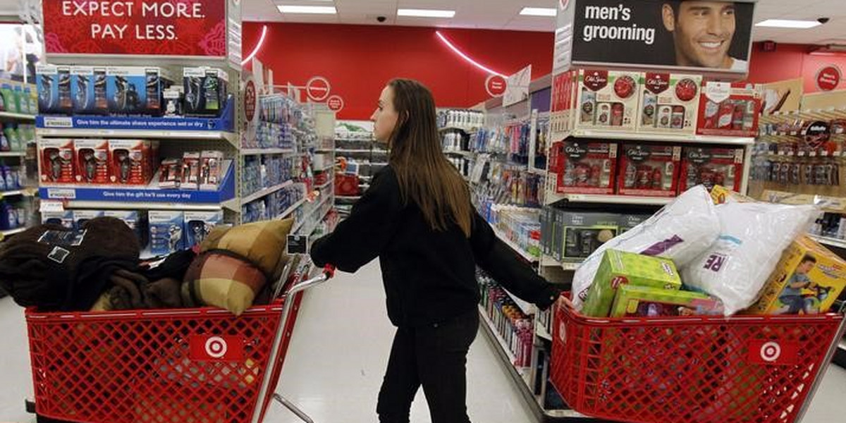 A woman pulls shopping carts through the aisle of a Target store on the shopping day dubbed "Black Friday" in Torrington