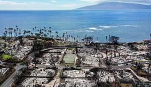 On October 9, a recovery vehicle drove past burned neighborhoods two months after wildfires devastated Lahaina, Hawaii.