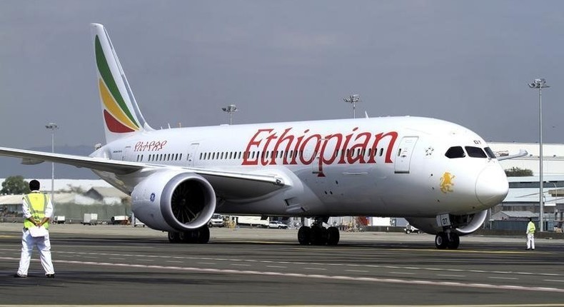 A member of the ground crew directs an Ethiopian Airlines plane at the Bole International Airport in Ethiopia's capital Addis Ababa, August 21, 2015.   REUTERS/Tiksa Negeri