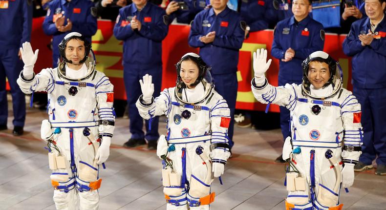 Astronauts Ye Guangfu, Zhai Zhigang and Wang Yaping wave during a ceremony ahead of the launch.
