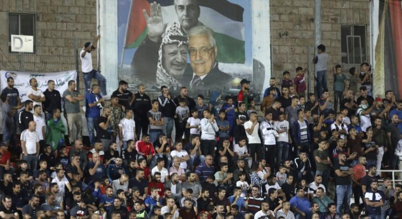 Spectators watch a match between Palestinian team Hilal al-Quds and Morocco's Raja Casablanca -- the first Moroccan football team to play in the occupied Palestinian territories on October 3, 2019