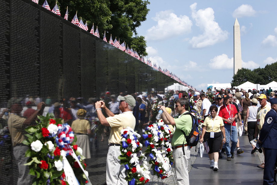 People visit the Vietnam Veterans Memorial wall, etched with the names of more than 58,000 U.S. servicemen and women who died in the war, on Memorial Day in Washington May 28, 2012.