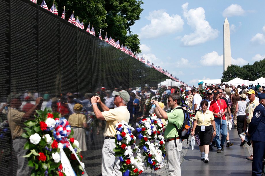 People visit the Vietnam Veterans Memorial wall, etched with the names of more than 58,000 U.S. servicemen and women who died in the war, on Memorial Day in Washington May 28, 2012.