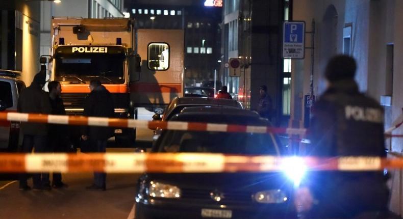 Swiss police are seen behind a police cordon outside a Muslim prayer hall, central Zurich, on December 19, 2016