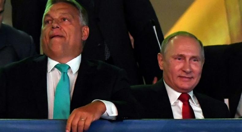 Russian President Vladimir Putin (R) sits next to Hungarian Prime Minister Viktor Orban during the World Judo Championships in Budapest on August 28, 2017