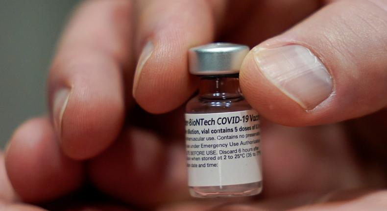 A healthcare worker holds a vial of the Pfizer coronavirus disease (COVID-19) vaccine at The University of Louisville Hospital in Louisville, Kentucky, U.S., December 14, 2020.
