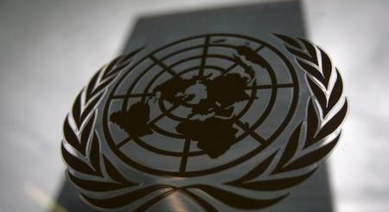 The United Nations headquarters building is pictured though a window with the UN logo in the foreground in the Manhattan borough of New York August 15, 2014.