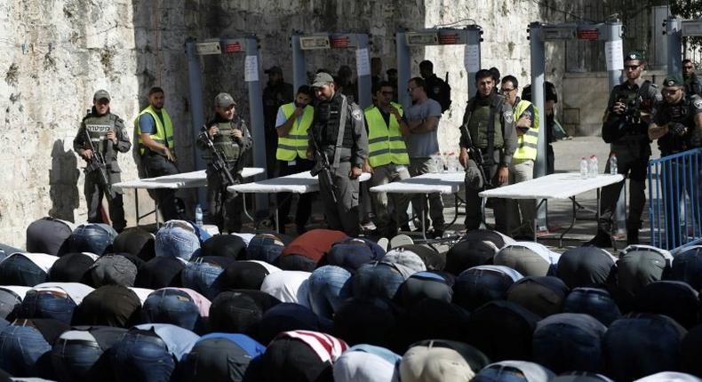 Palestinian Muslim worshippers refuse to enter the Al-Aqsa mosque compound after Israeli set up metal detectors and cameras as part of new security measures