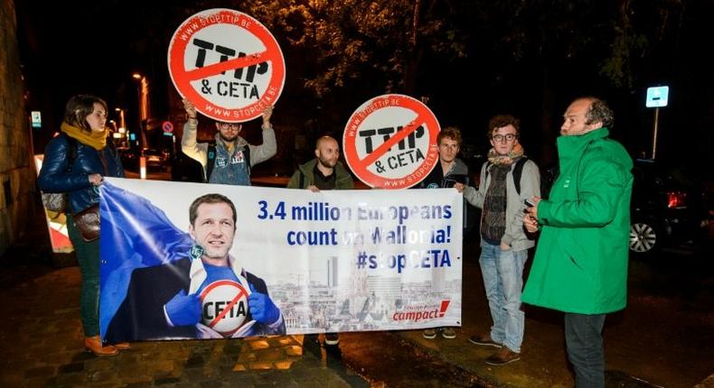 Protesters hold up a placard reading '3,4 million Europeans count on Wallonia - stop CETA' during a demonstration in as a meeting in Namur, on October 18, 2016