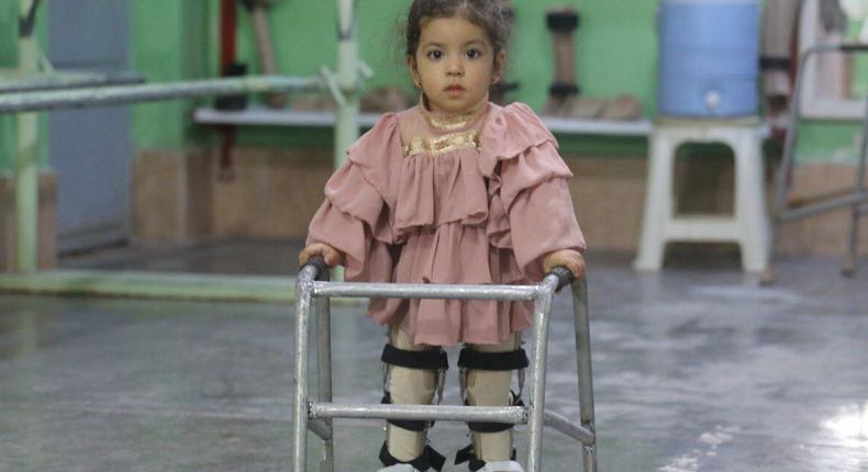 A physically disabled girl walks with a walker at the physically disabled center of the International Committee of the Red Cross in Herat, Afghanistan on September 02, 2021. The center is the only disability support center in Afghanistan.
