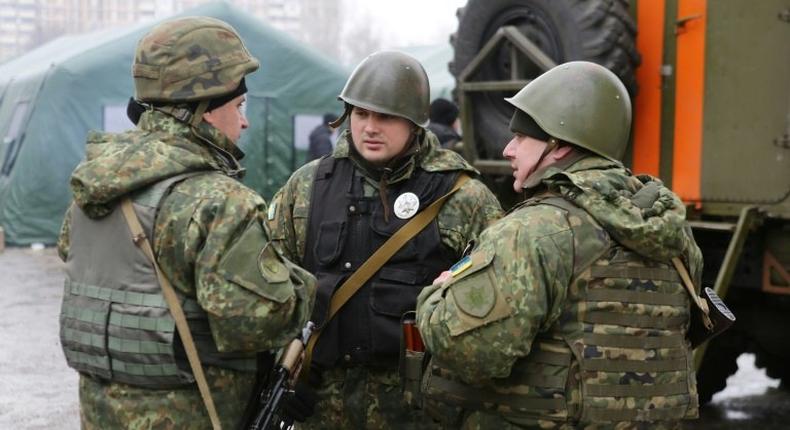 Ukrainian servicemen talk in the streets of Avdiivka, Donetsk region, on February 5, 2017