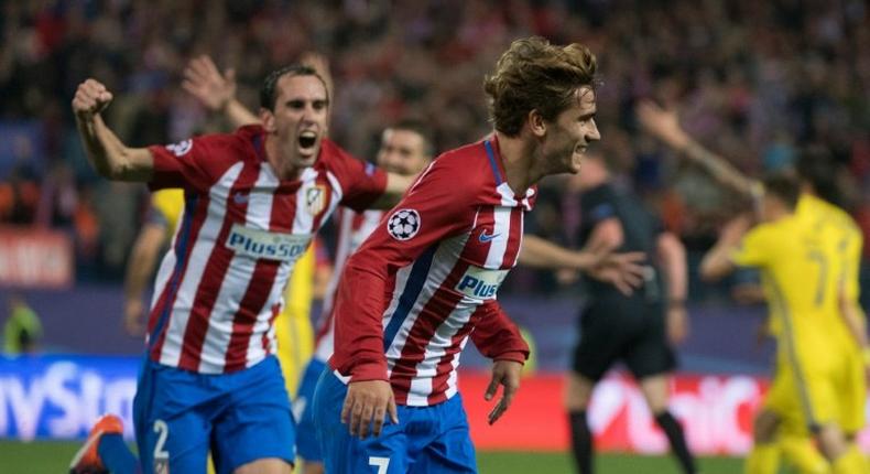 Atletico Madrid's French forward Antoine Griezmann (R) celebrates after scoring against FC Rostov in Madrid, on November 1, 2016