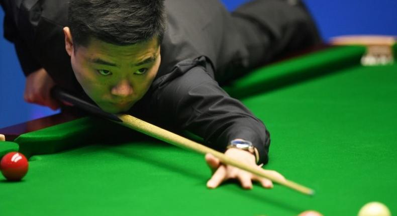 China's Ding Junhui plays a shot against China's Zhou Yuelong during their first round game of the World Snooker Championships in Sheffield, northern England, on April 18, 2017