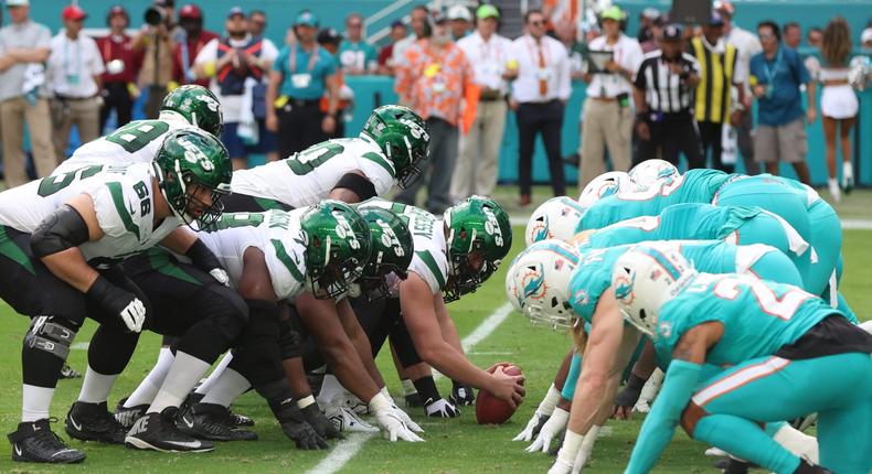 Players for the New York Jets and the Miami Dolphins lined up for a play.Petty Knotts / Getty Images