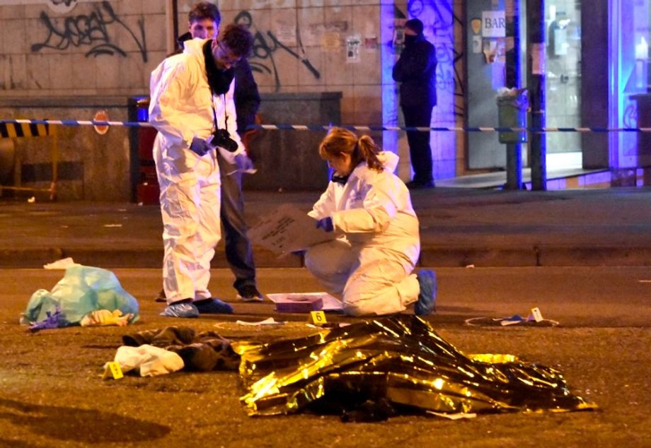 The body of Anis Amri, the suspect in the Berlin Christmas market truck attack, is seen covered with a thermal blanket next to Italian officers in a suburb of the northern Italian city of Milan, Italy December 23, 2016.