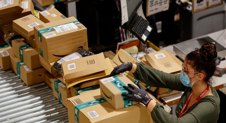 An employee handles packages at the Amazon's Bretigny-sur-Orge warehouse in France.