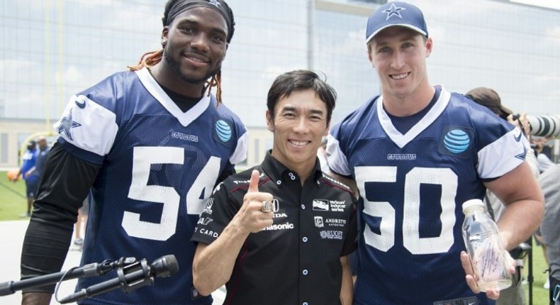 Indianapolis 500 Champion Takuma Sato (C) stands with Jaylon Smith and Sean Lee of the Dallas Cowboys in Frisco, Texas