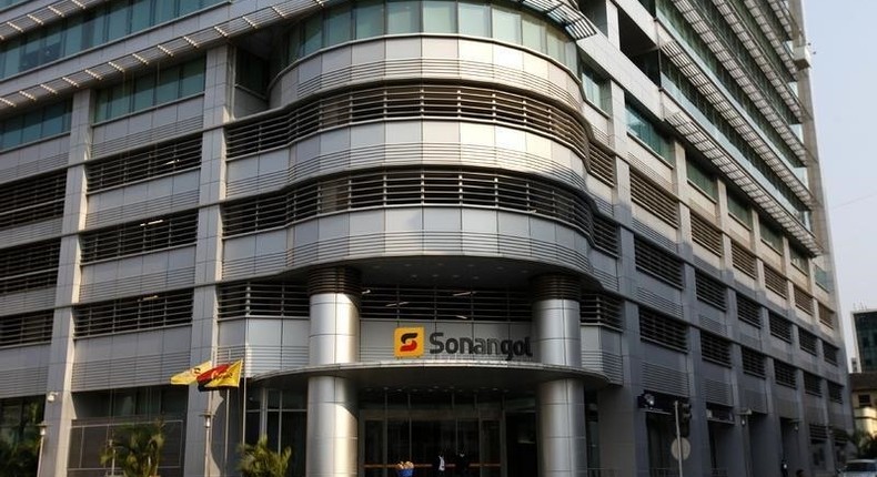 A woman walks past the head office of Angolan state oil company Sonangol in the capital Luanda, August 26, 2012. 