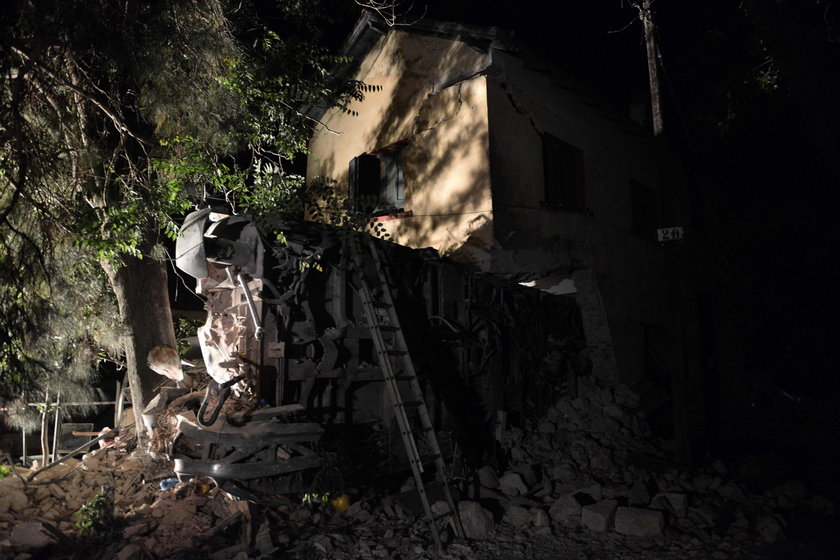 A derailed train carriage is seen toppled in the town of Adendro in northern Greece