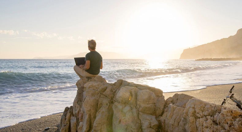 A California millennial says secretly working two remote jobs helped him save for an early retirement — but that he's happy he's back to just one job. Ascent/ PKS Media Inc./Getty Images