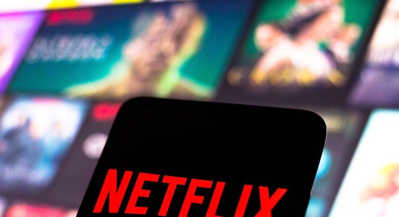 The Netflix logo is displayed on a smartphone screen.