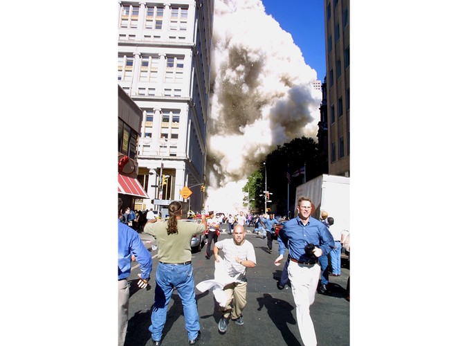 Przechodnie uciekają przed pyłem z zawalającej się po zamachu terrorystycznym wieży World Trade Center w Nowym Jorku