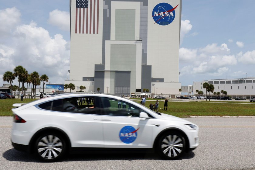 NASA astronauts Douglas Hurley and Robert Behnken head to launch pad 39 to board a SpaceX Falcon 9 r