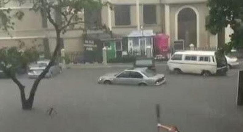 An expat seen paddling a canoe in flooded Victoria Island.