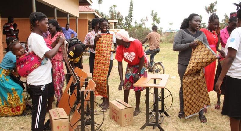 Beneficiaries of the tailoring training just after receiving their start up kits including sewing machines fabric and other items (Photo credit: Windle International Uganda)