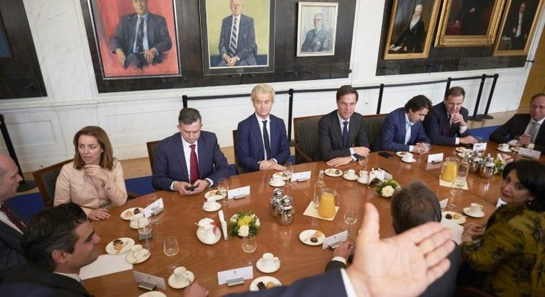 Dutch Prime Minister Mark Rutte (background 4thR) and Dutch PVV leader Geert Wilders (C) pose with other party leaders before a meeting with Chairman of the Senate Khadija Arib (4thL) in The Hague, on March 16, 2017, a day after general elections